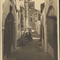 Monemvasia narrow pared street with belltower in the background